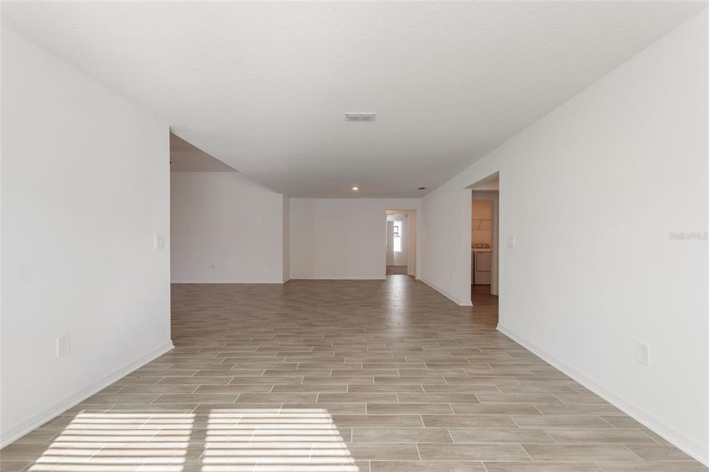 5767 Talc St Mount Mount Dora, FL 32757 - Photo 12 of 44 a view of a hallway with wooden floor