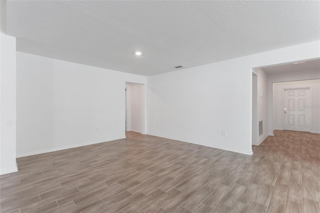5767 Talc St Mount Mount Dora, FL 32757 - Photo 13 of 44 a view of an empty room with wooden floor