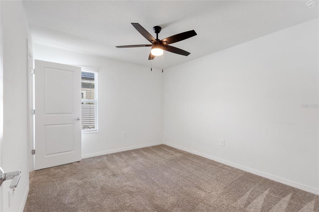 5767 Talc St Mount Mount Dora, FL 32757 - Photo 15 of 44 an empty room with closet and ceiling fan