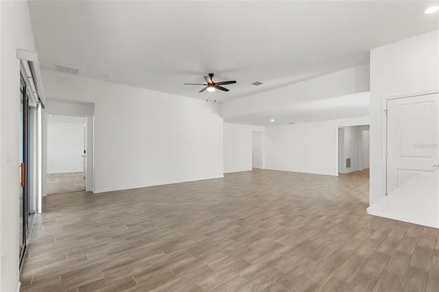 a view of an empty room with a ceiling fan