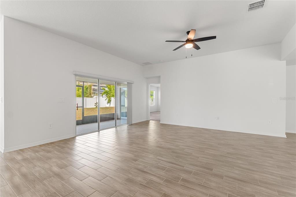 5767 Talc St Mount Mount Dora, FL 32757 - Photo 22 of 44 a view of an empty room with a window and wooden floor