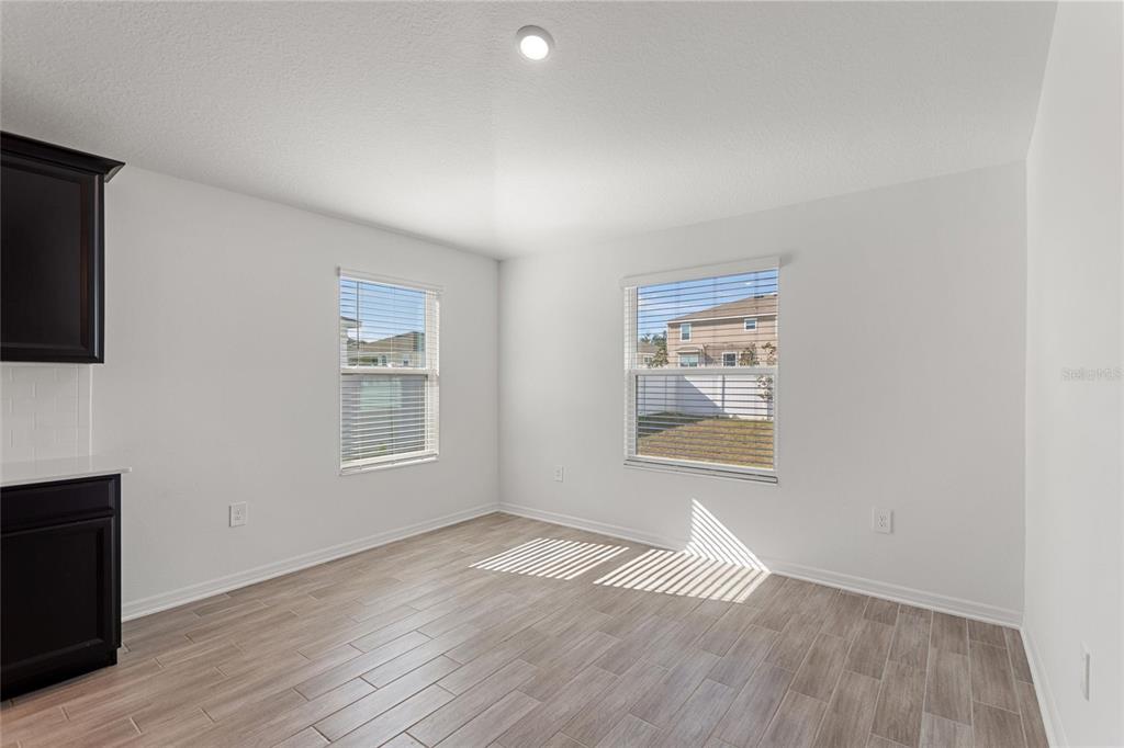 5767 Talc St Mount Mount Dora, FL 32757 - Photo 28 of 44 an empty room with wooden floor and windows