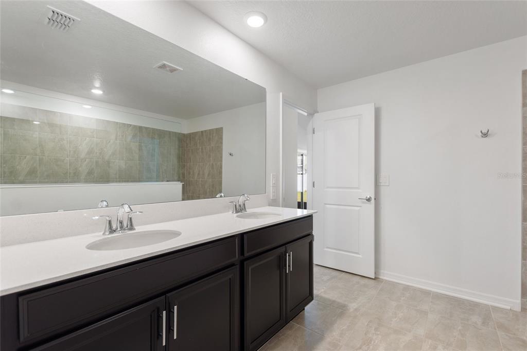 5767 Talc St Mount Mount Dora, FL 32757 - Photo 33 of 44 a bathroom with a sink and a mirror