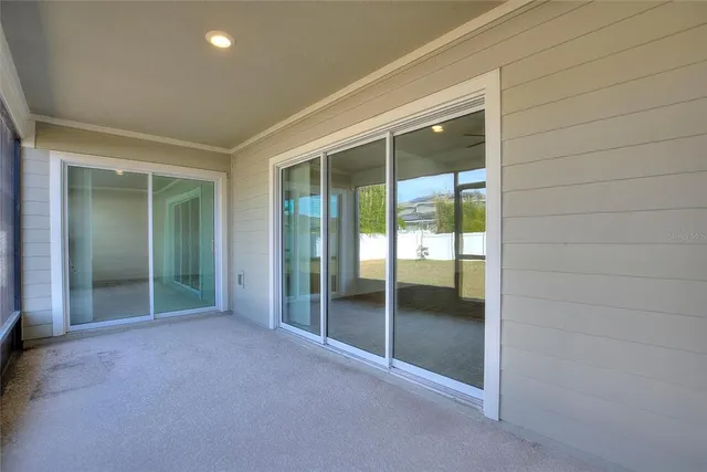 an empty room with sliding glass door and shower
