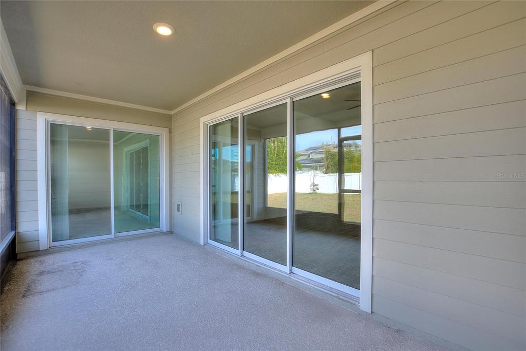5767 Talc St Mount Mount Dora, FL 32757 - Photo 35 of 44 an empty room with sliding glass door and shower
