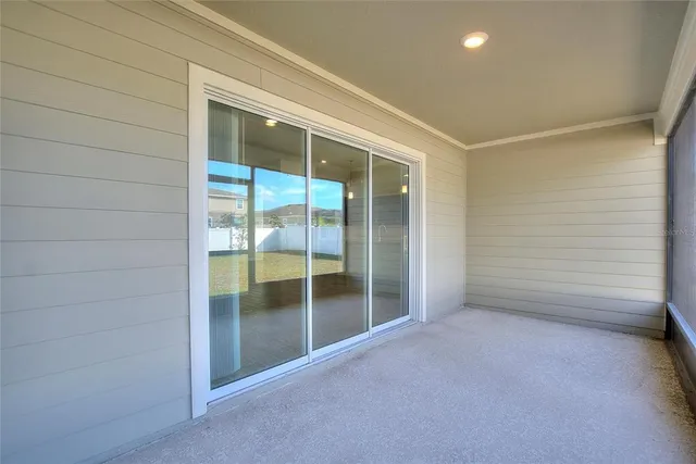 an empty room with sliding glass door and shower