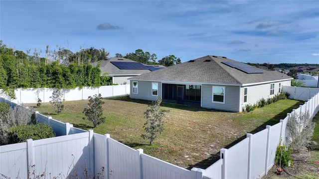 a aerial view of a house with a yard
