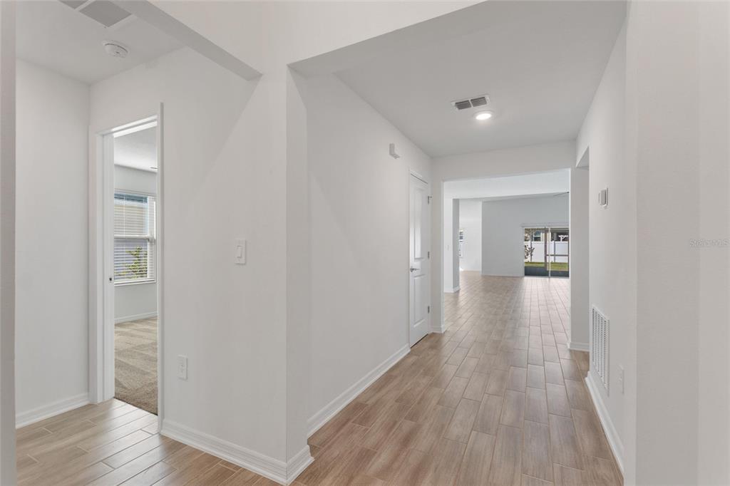 5767 Talc St Mount Mount Dora, FL 32757 - Photo 4 of 44 a view of a hallway with wooden floor