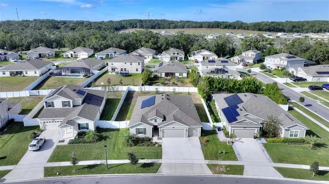 an aerial view of a house with lots of trees