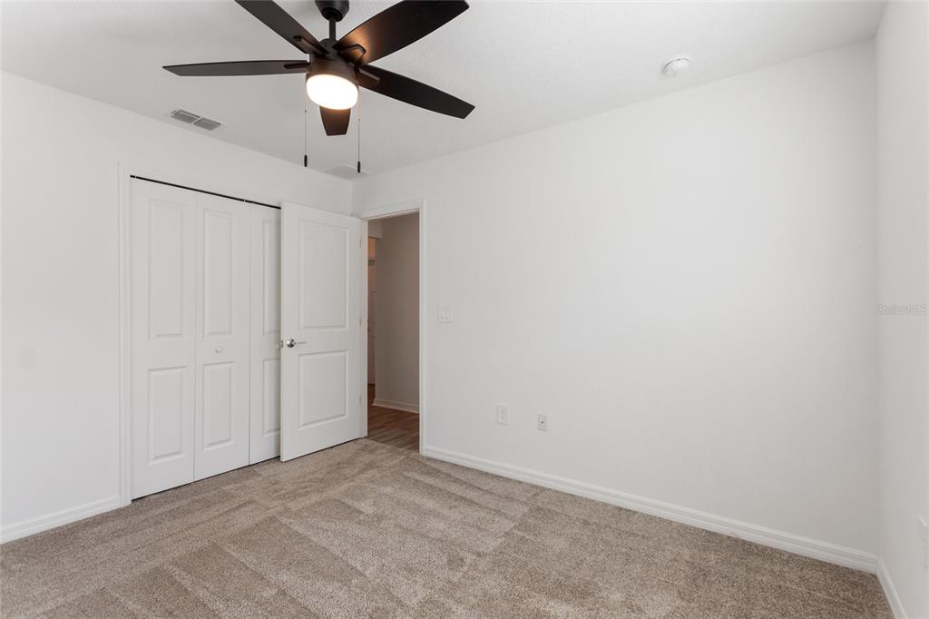 5767 Talc St Mount Mount Dora, FL 32757 - Photo 9 of 44 an empty room with a ceiling fan and a ceiling fan