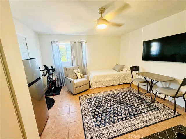 a bedroom with furniture and a flat screen tv