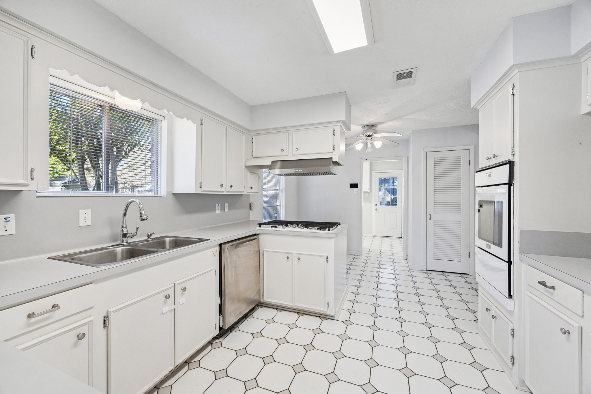 8730 Cedarspur Drive Houston, TX 77055 - Photo 11 of 23 a kitchen with a sink cabinets and window