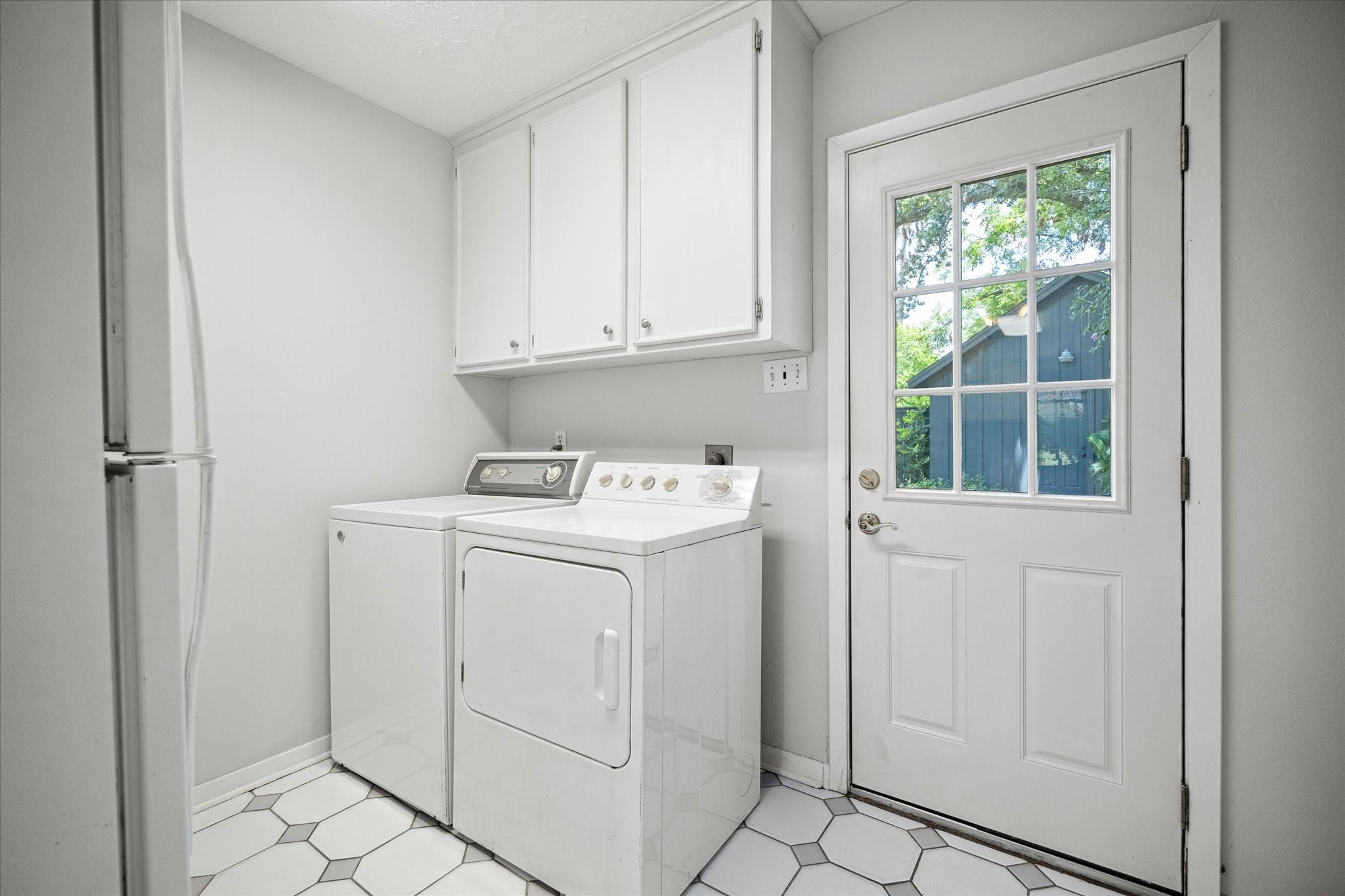 8730 Cedarspur Drive Houston, TX 77055 - Photo 15 of 23 a utility room with cabinets washer and dryer
