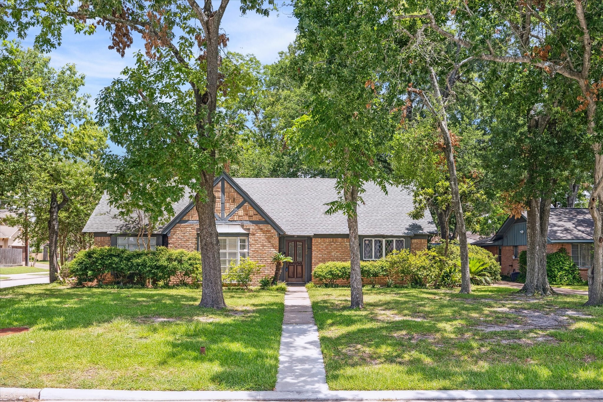 8730 Cedarspur Drive Houston, TX 77055 - Photo 23 of 23 a front view of a house with a yard and trees
