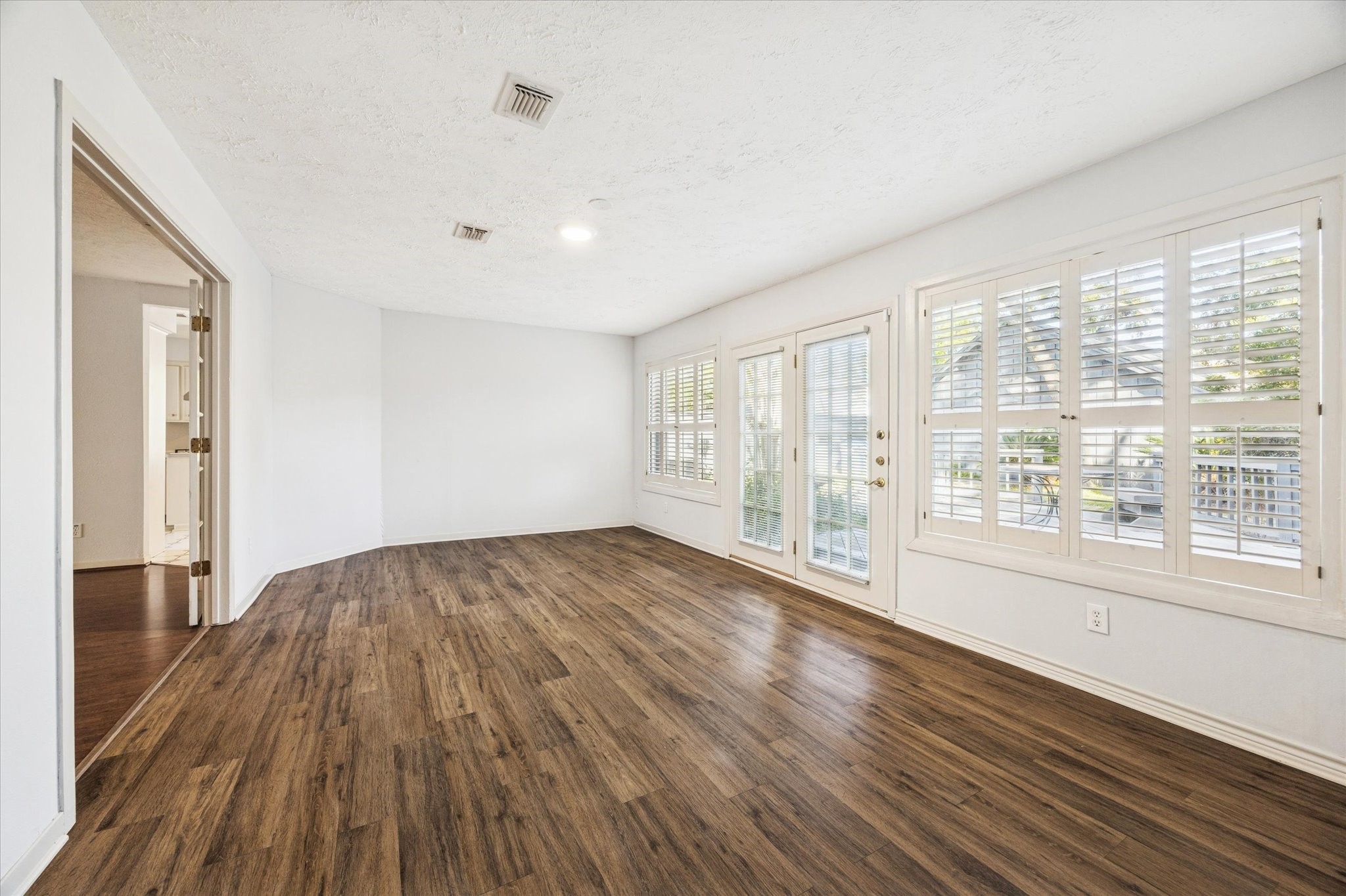 8730 Cedarspur Drive Houston, TX 77055 - Photo 8 of 23 a view of an empty room with wooden floor and a window