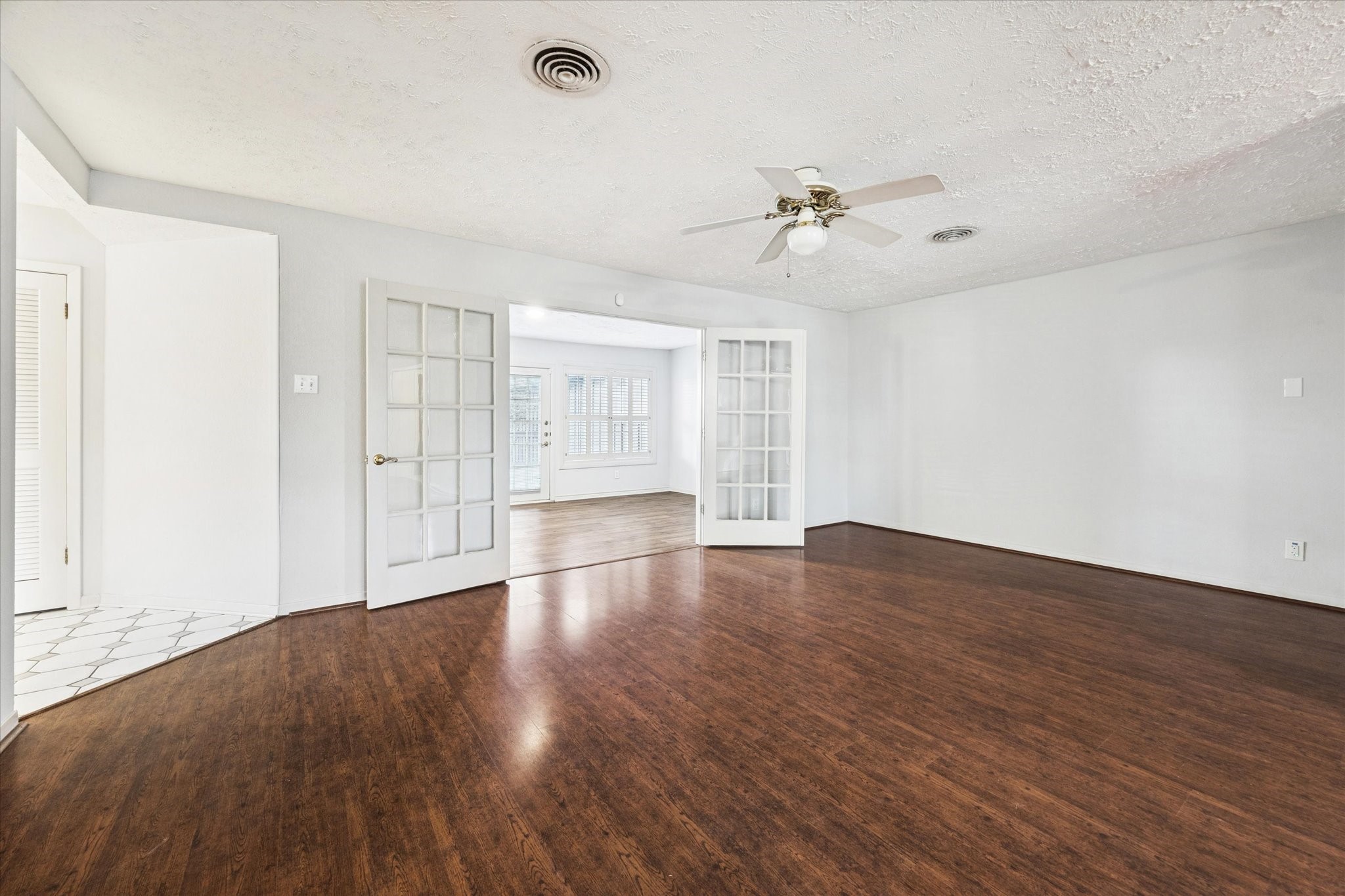 8730 Cedarspur Drive Houston, TX 77055 - Photo 9 of 23 an empty room with wooden floor ceiling fan and windows