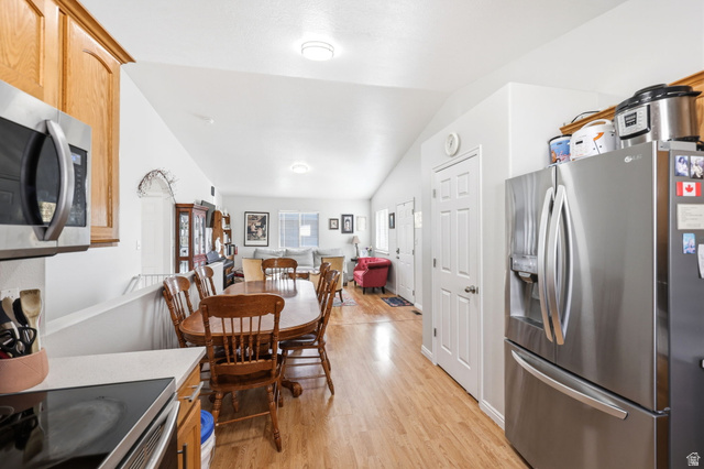 1662 East Ridgefield Road Spanish Fork, UT 84660 - Photo 6 of 18 Kitchen and dining area featuring wood-finish flooring, light wood cabinetry, stainless steel appliances, and a built-in microwave