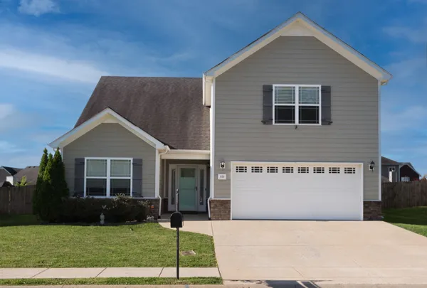 a front view of a house with a yard and garage