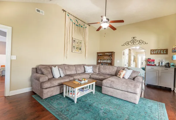 a living room with furniture and a chandelier
