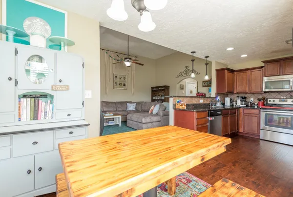 a kitchen with kitchen island granite countertop wooden cabinets and a stove