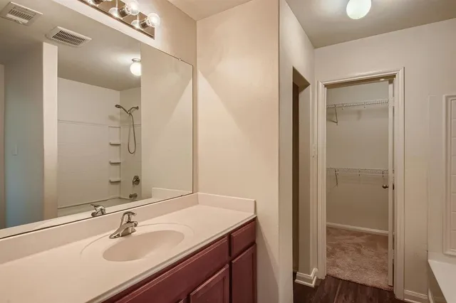 a bathroom with a sink double vanity and a mirror