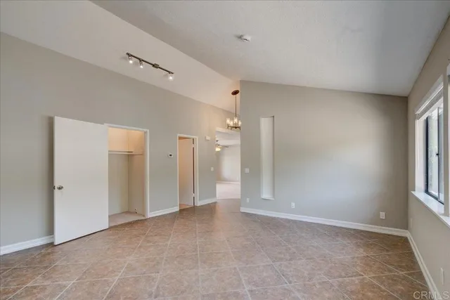 an empty room with a fireplace and windows
