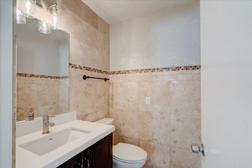 18434 Ramona View Drive Ramona, CA 92065 - Photo 15 of 72 a bathroom with a sink toilet a mirror and shower