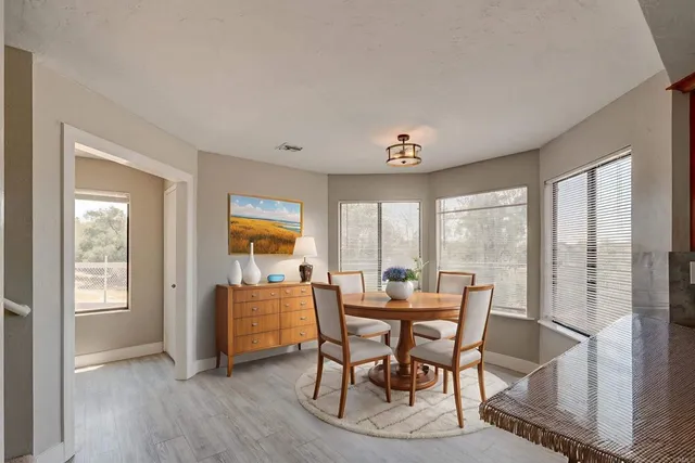 a dining room with furniture and window