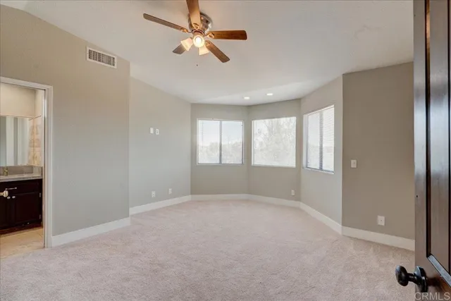 a front view of a house with a yard and potted plants
