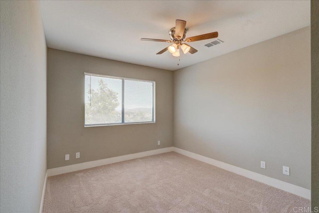 18434 Ramona View Drive Ramona, CA 92065 - Photo 40 of 72 an empty room with a window and a fan