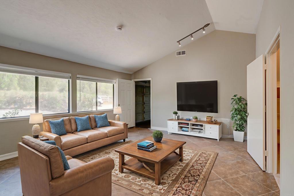 18434 Ramona View Drive Ramona, CA 92065 - Photo 4 of 72 a living room with furniture a flat screen tv and a large window