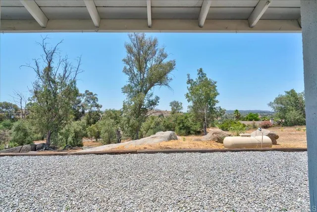 an aerial view of a house with yard and mountain view in back