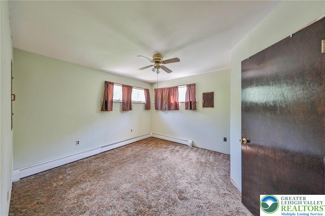 331 Cranberry Creek Road Cresco, PA 18326 - Photo 54 of 95 A well-lit bedroom featuring a functional ceiling fan, ready for personal touches and new flooring.