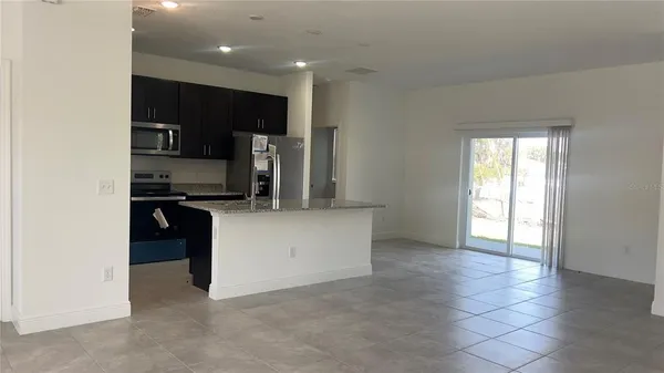 a kitchen with stainless steel appliances a refrigerator and a stove top oven