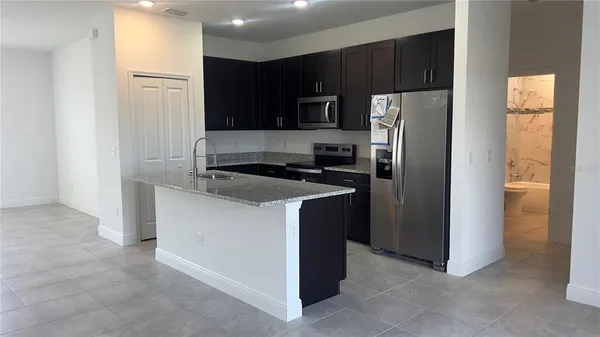 a kitchen with a refrigerator stove and microwave
