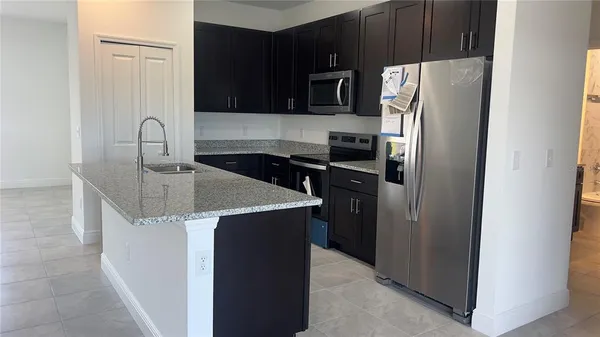 a kitchen with a refrigerator sink and microwave