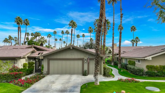 a kitchen with stainless steel appliances kitchen island granite countertop a table and chairs in it