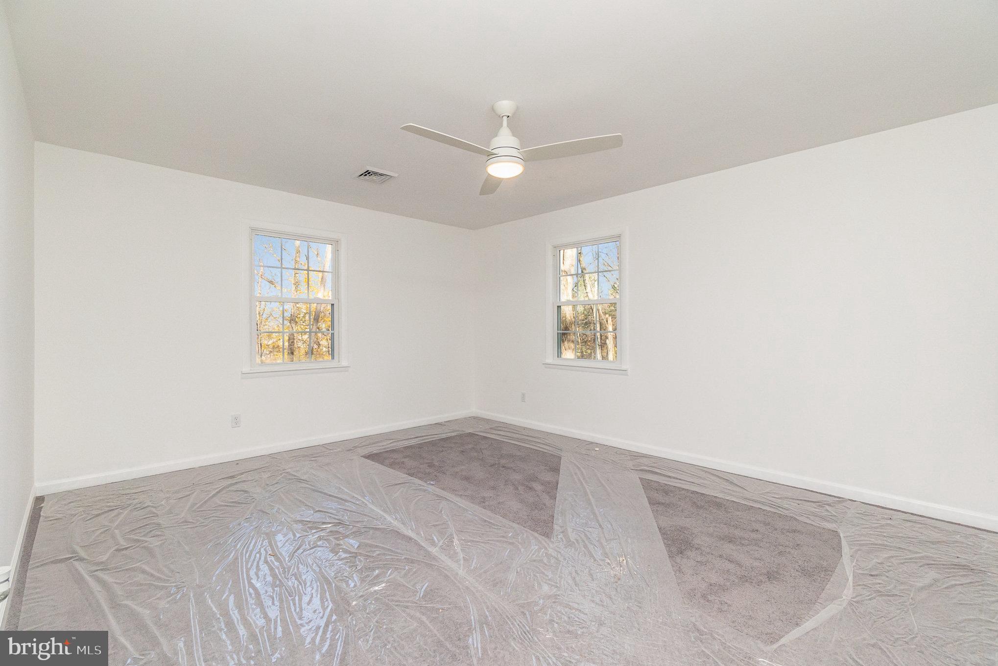 5505 Williams Road Hydes, MD 21082 - Photo 15 of 42 an empty room with windows and ceiling fan