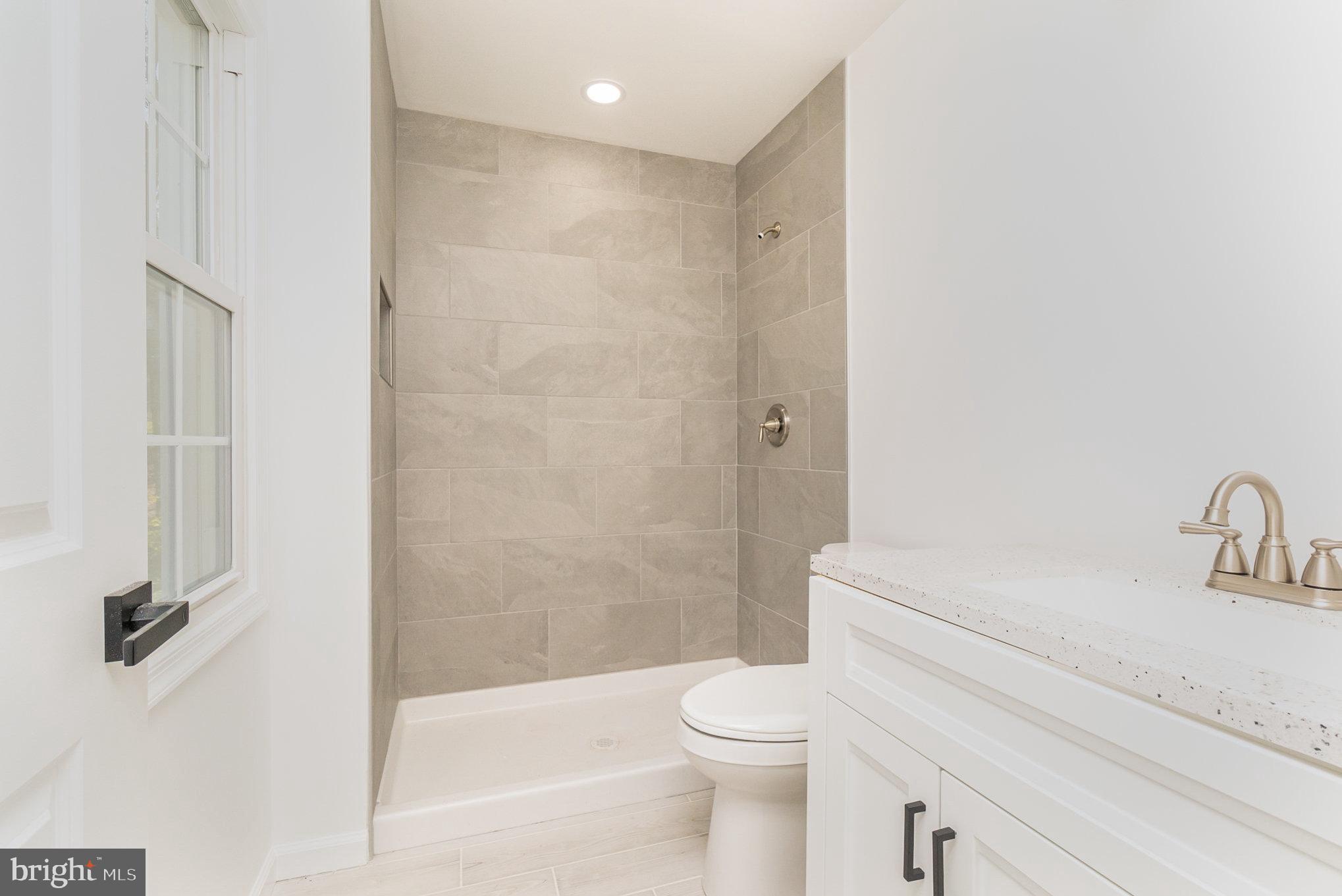 5505 Williams Road Hydes, MD 21082 - Photo 17 of 42 a bathroom with a shower a toilet and a sink