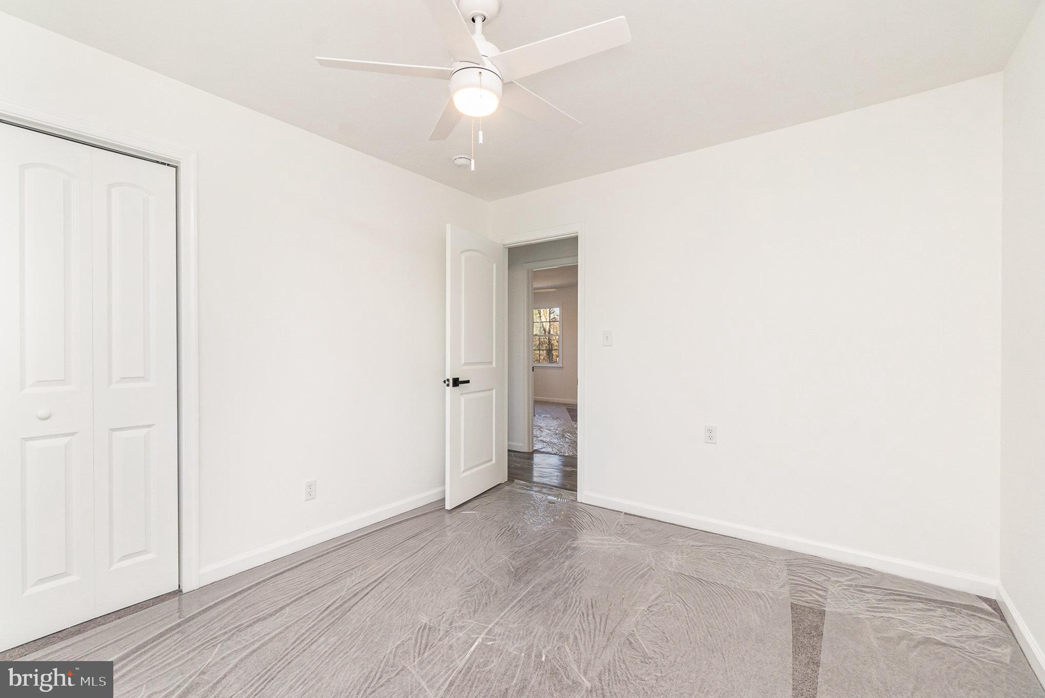 5505 Williams Road Hydes, MD 21082 - Photo 19 of 42 an empty room with a ceiling fan and a window