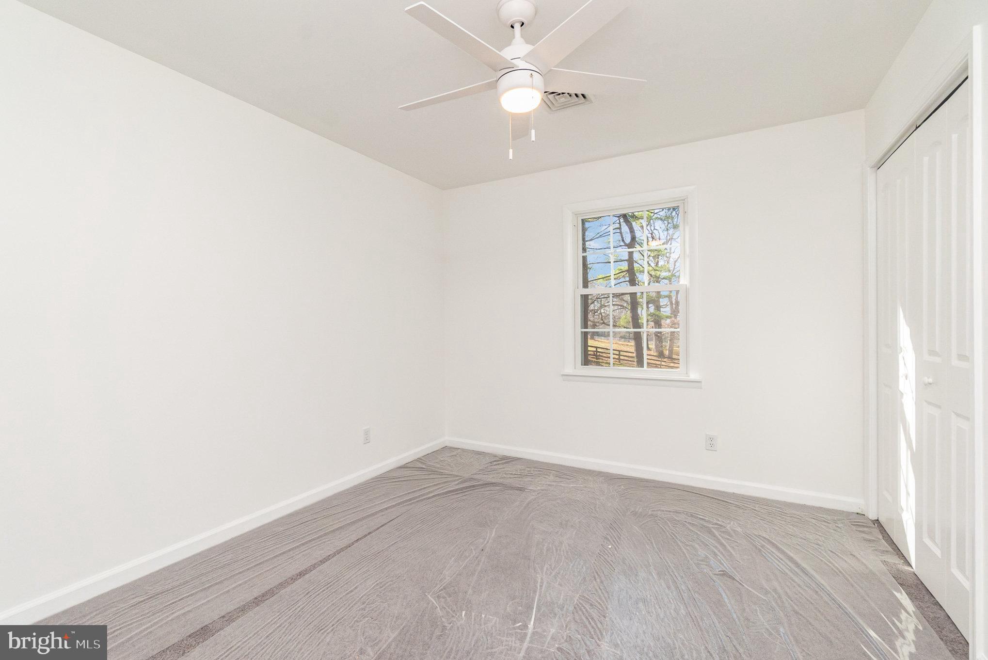 5505 Williams Road Hydes, MD 21082 - Photo 21 of 42 an empty room with a window and a fan