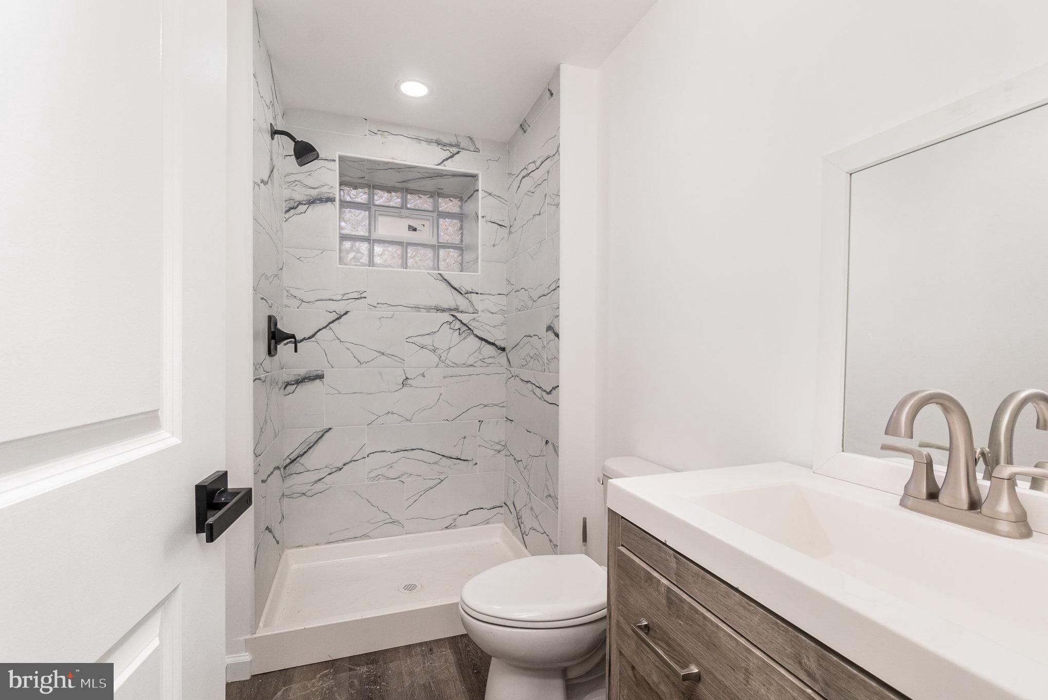 5505 Williams Road Hydes, MD 21082 - Photo 26 of 42 a bathroom with a sink toilet and shower
