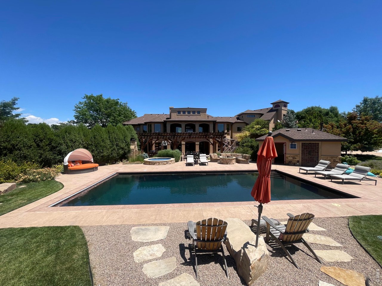 964 Riparian Way Fort Collins, CO 80524 - Photo 37 of 42 a view of swimming pool with lawn chairs under an umbrella