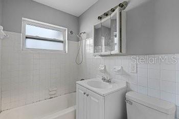 1533 North Normandy Boulevard Deltona, FL 32725 - Photo 12 of 15 a bathroom with a sink a toilet and shower