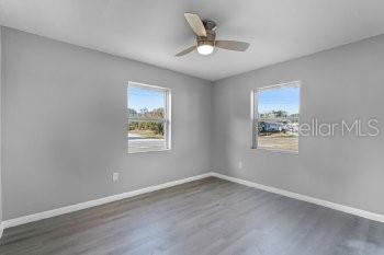 1533 North Normandy Boulevard Deltona, FL 32725 - Photo 13 of 15 wooden floor in an empty room with a window