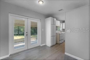 1533 North Normandy Boulevard Deltona, FL 32725 - Photo 6 of 15 a view of a kitchen with refrigerator and white cabinets