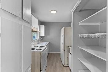 1533 North Normandy Boulevard Deltona, FL 32725 - Photo 8 of 15 a kitchen with stainless steel appliances kitchen island a refrigerator sink and stove