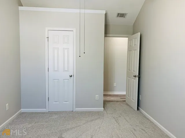 an empty room with closet area