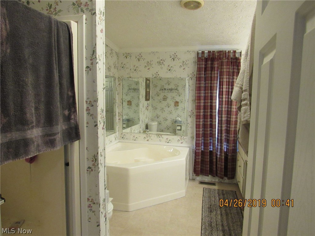 4502 Tower Road Dorset, OH 44032 - Photo 11 of 16 Master bathroom offers a stand alone shower, a soaker tub and double sink vanity.