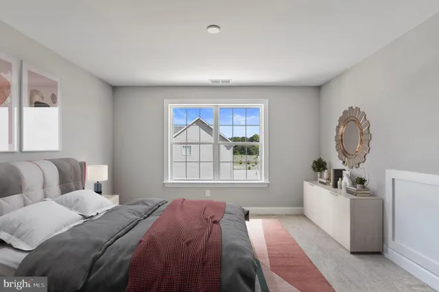 a bed room with a bed and a window